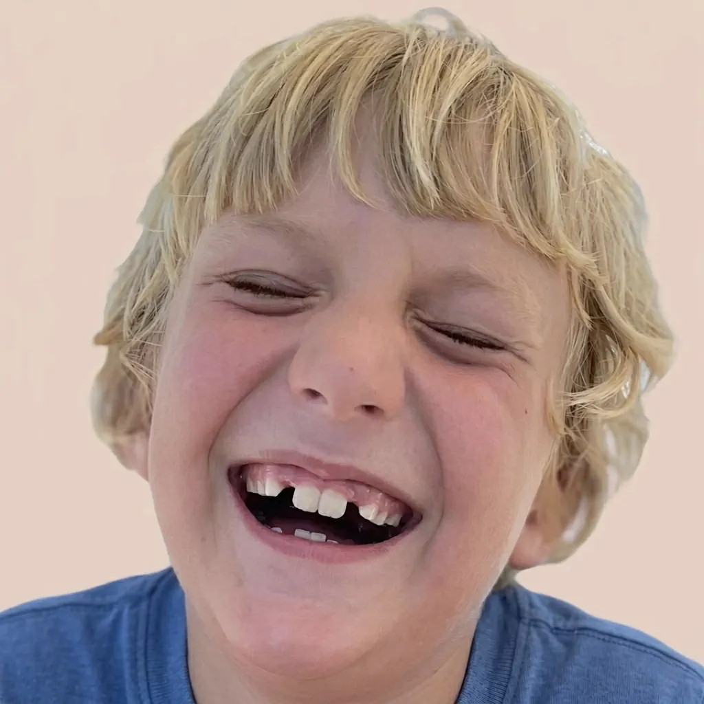 Happy child smiling after a gentle dental hygiene visit at Bright White Dental Hygiene in Riverview, NB